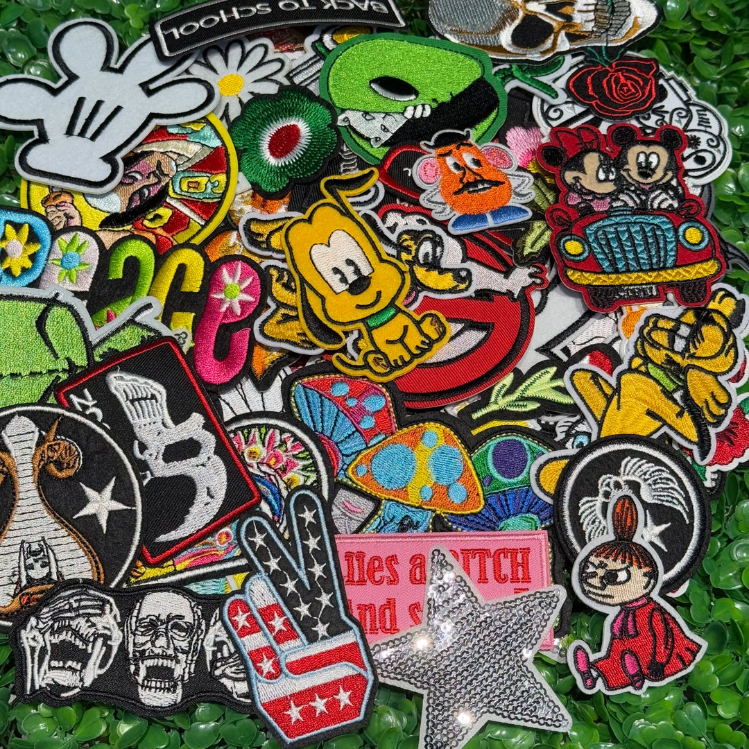 Collection of various colorful patches on a green textured background