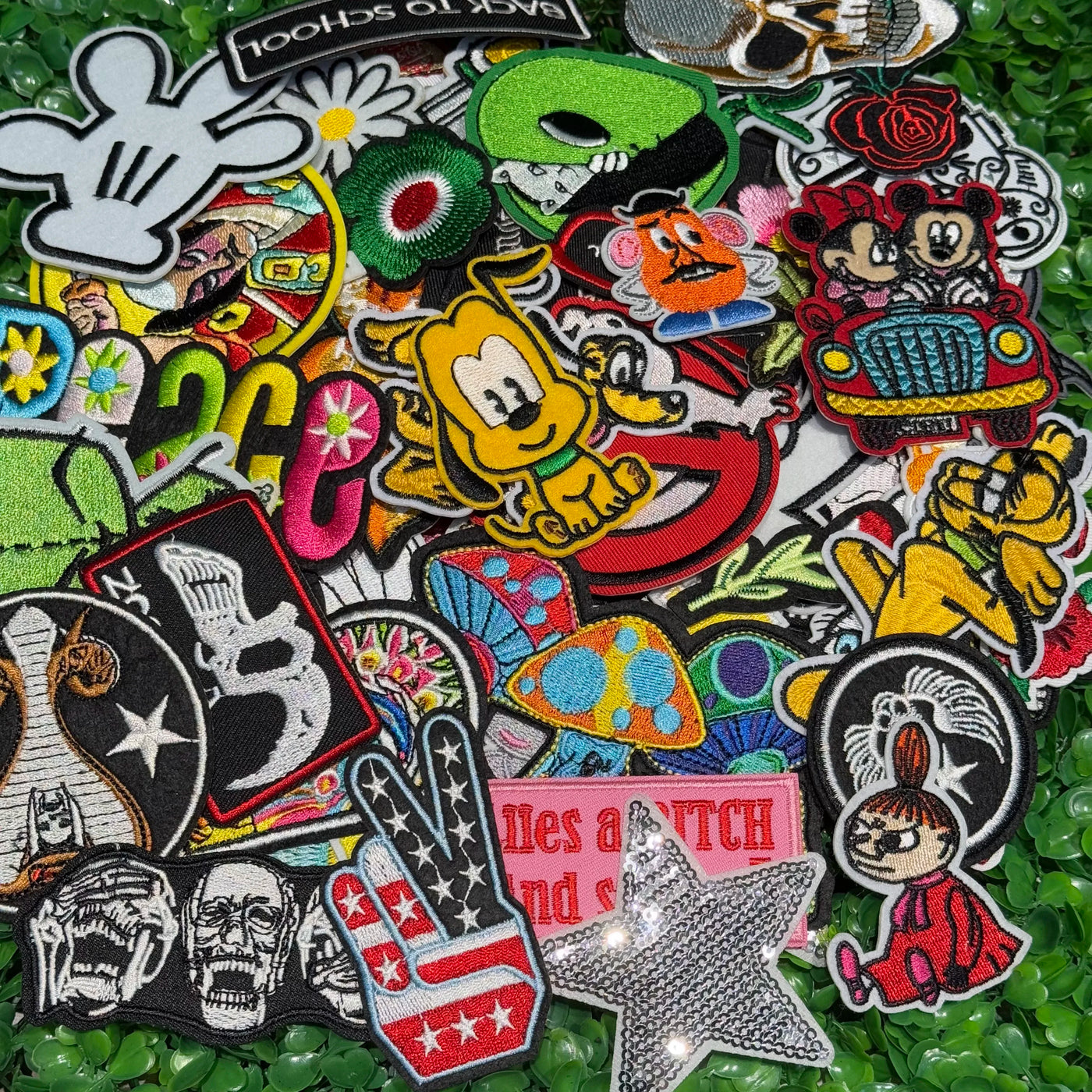 Collection of various colorful patches on a green textured background
