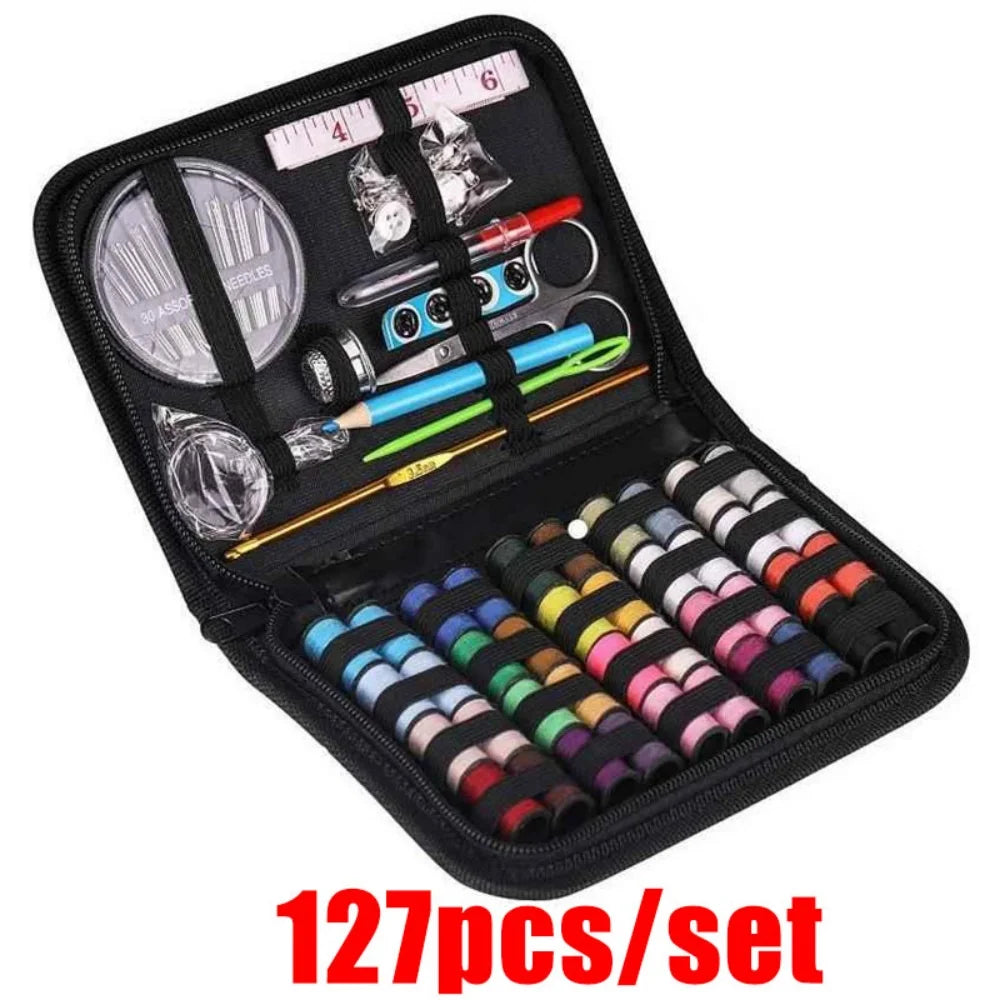 Sewing kit with various tools and colorful thread spools in a black case 127 pieces kit on a white background.