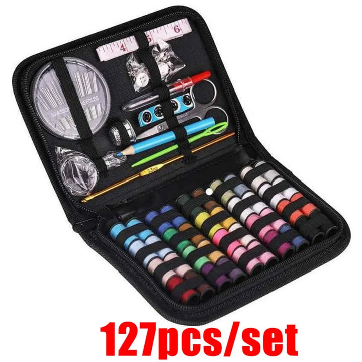 Sewing kit with various tools and colorful thread spools in a black case 127 pieces kit on a white background.