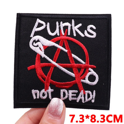 Embroidered patch with 'Punks not Dead!' text and an anarchy symbol held by a hand.