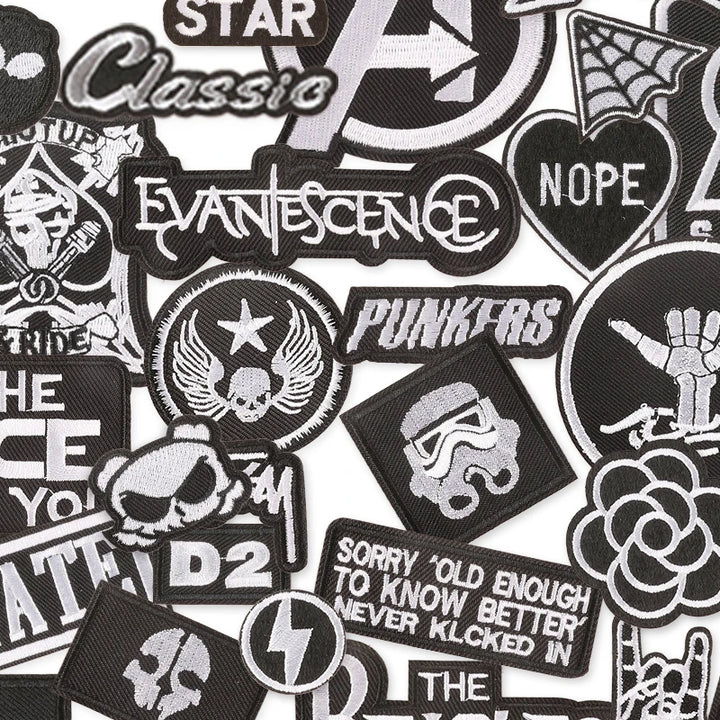 Collection of various black and white patches with different designs and text.