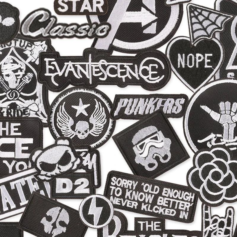 Collection of various black and white patches with different designs and text.
