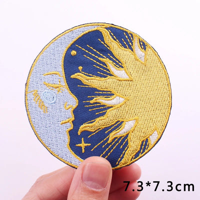 Circular patch with embroidered design held by a hand on a light purple background