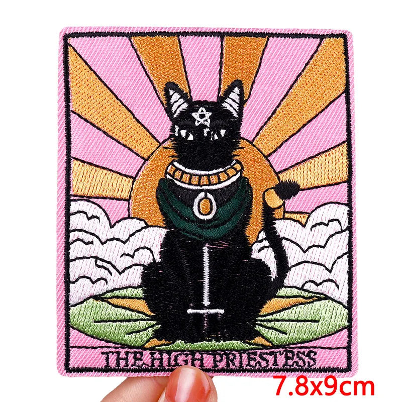 Embroidered patch of a black cat with a colorful background