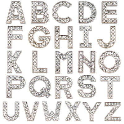 Silver rhinestone letters shoe charms on a white background