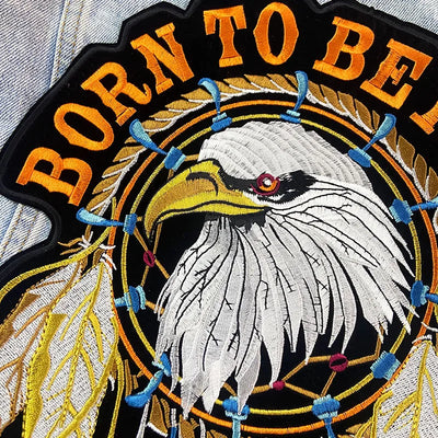 Embroidered patch with an eagle design and 'Born to Be' text on a black background