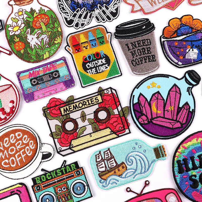 Collection of colorful embroidered patches with various designs on a white background