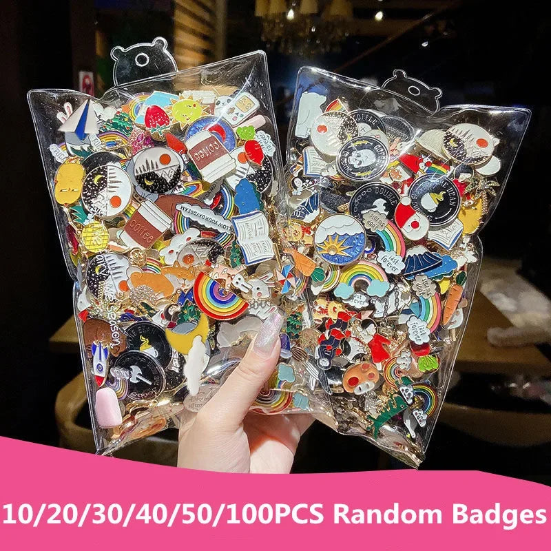 Two clear packages filled with colorful random badges held by a hand.