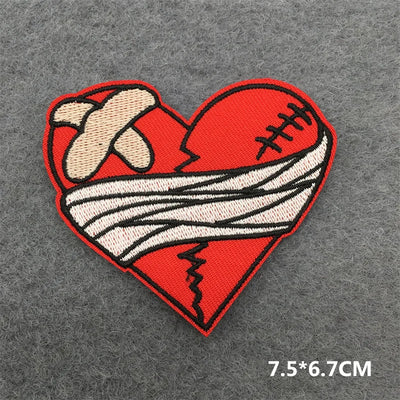 Heart-shaped patch with a bandaged hand on a gray background