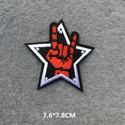 Patch with a hand making a peace sign inside a star on a gray background