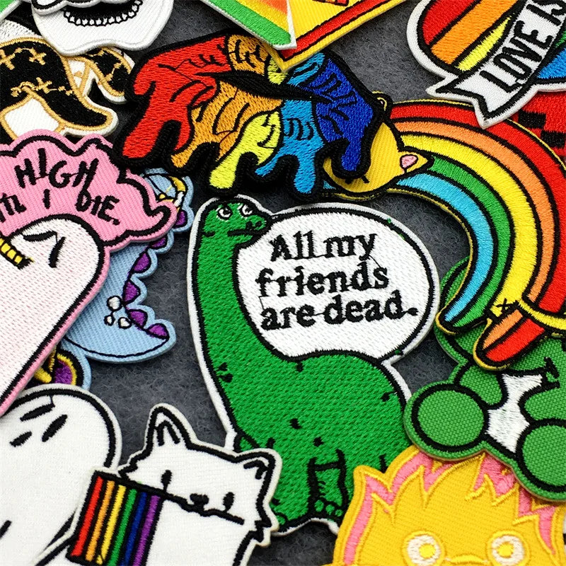 Collection of colorful patches with various designs and text on a black background