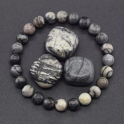 Bracelet made of marbled stones on a dark background