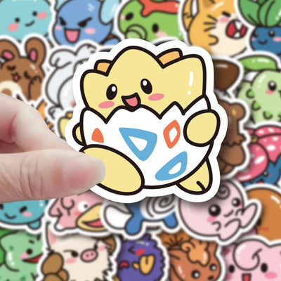 Sticker of a cute animal character in an egg with a hand holding it, surrounded by various other colorful stickers.