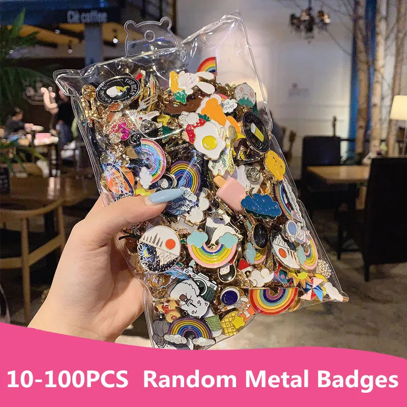 Hand holding a clear bag filled with colorful metal badges in an indoor setting.