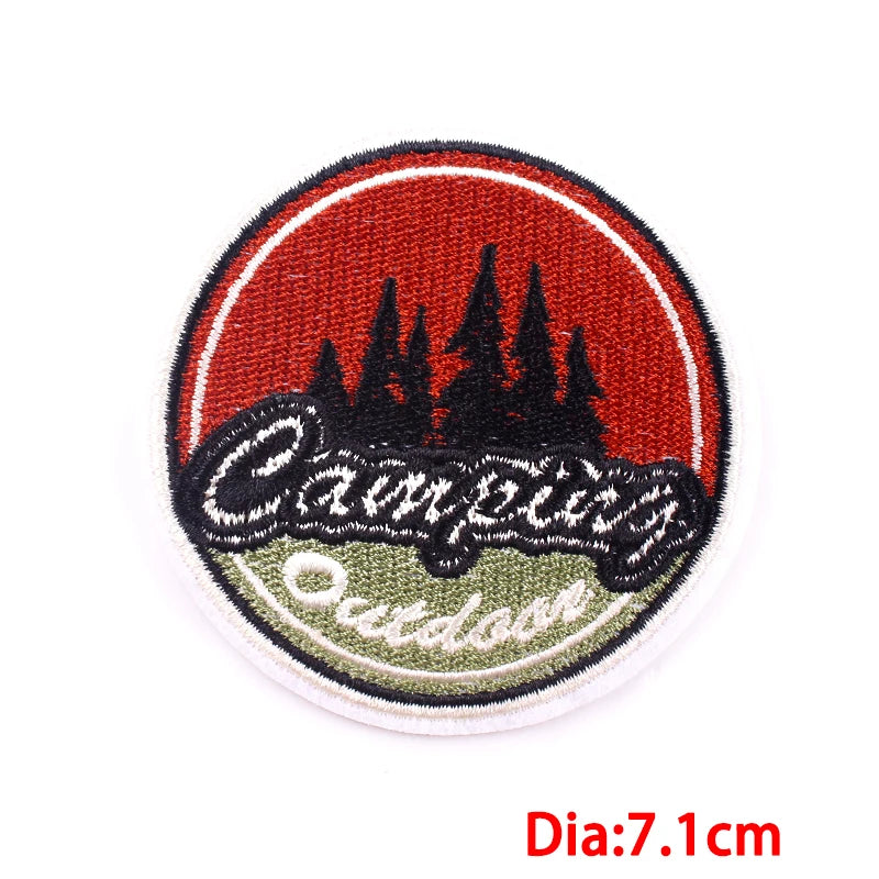 Round embroidered patch with 'Campfire Outdoors' text and forest design on a red background.