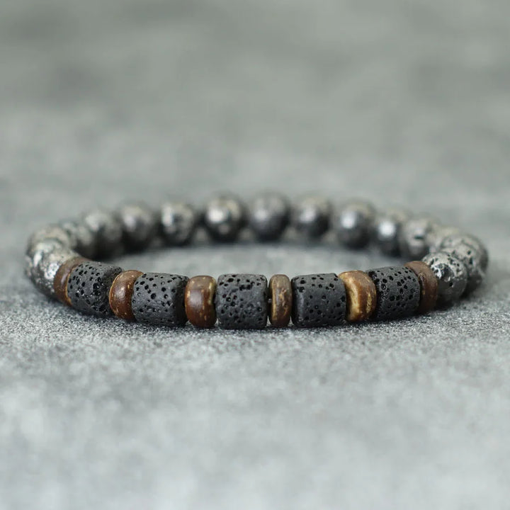 Bracelet with black and brown beads on a gray surface