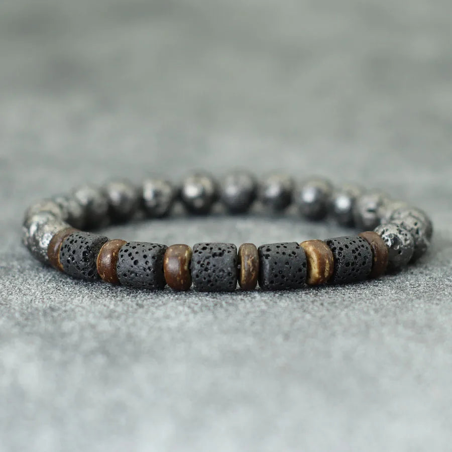 Bracelet with black and brown beads on a gray surface