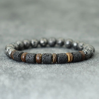 Bracelet with black and brown beads on a gray surface