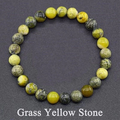 Beaded bracelet with grass yellow stone beads on a dark gray background