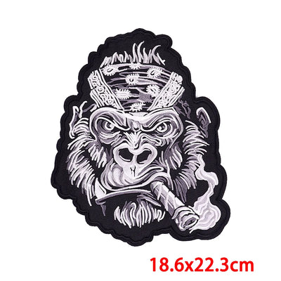Stylized monkey head patch with crown on a white background, featuring dimensions.