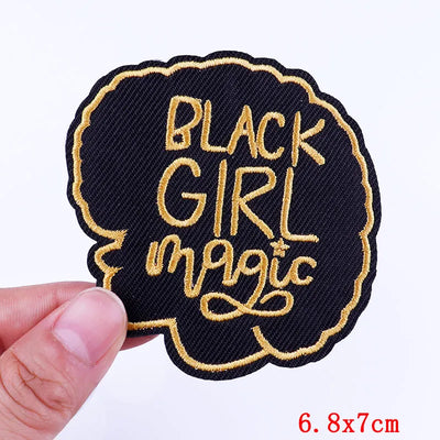 BlackGirlMagic patch held by a hand with a white background