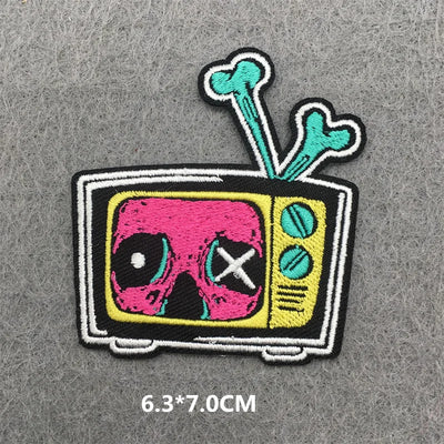 Patch of a TV with a skull design on a gray background