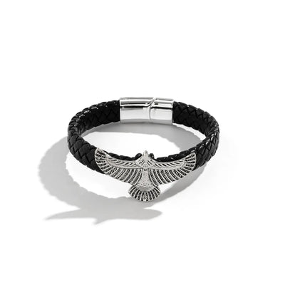 Black braided leather bracelet with silver eagle pendant on a white background