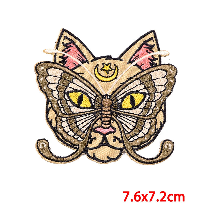 Butterfly-shaped patch with cat face design on a white background