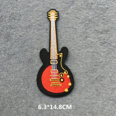 Guitar-shaped patch on a gray background with size indication