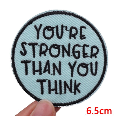 Circular patch with motivational text held by a hand, size indicated as 6.5cm.