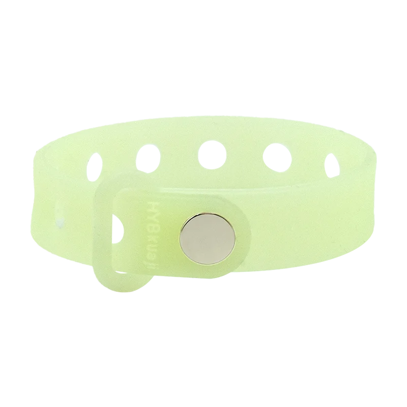 Luminous green wrist band with a central round metal component on a white background