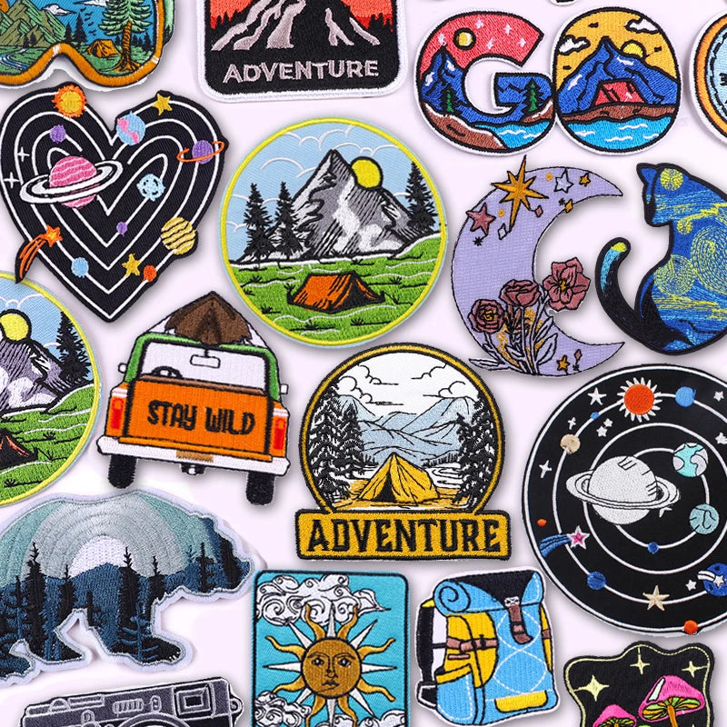 Collection of colorful adventure-themed patches on a white background