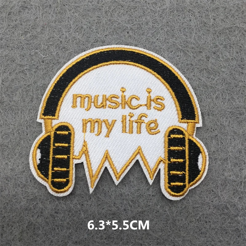 Embroidered patch with 'music is my life' text and headphones design on a gray background.