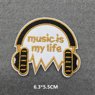 Embroidered patch with 'music is my life' text and headphones design on a gray background.