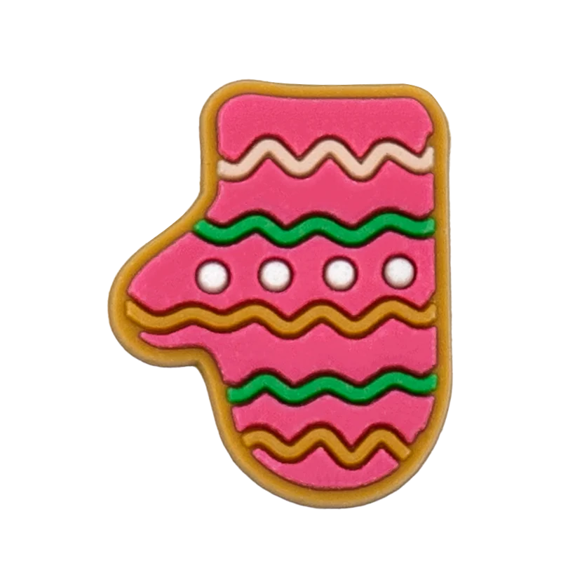Shoe charm ornament of Pink gingerbread cookie shaped like a stocking with green and brown decorations on a white background