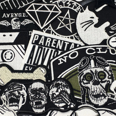 Collection of various patches with different designs including skulls, text, and symbols.