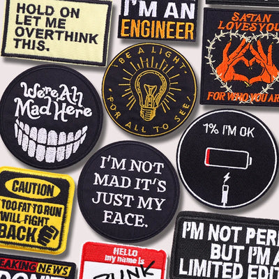 Collection of various patches with humorous and bold text designs.