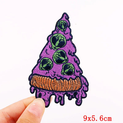 Purple ice cream cone with green cherries patch held by a hand on a white background