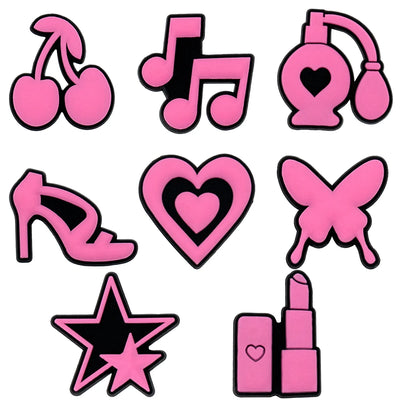 Collection of pink shoe charms including cherries, music notes, perfume bottles, high heels, hearts, butterflies, stars, and lipstick on a white background.