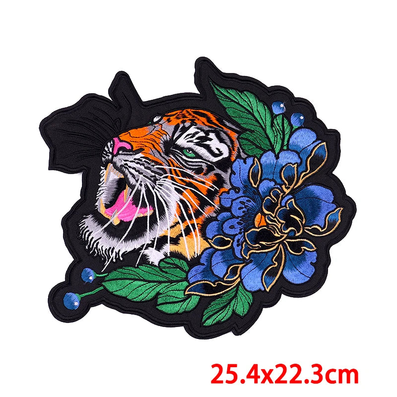 Embroidered patch with a tiger and blue flowers on a white background