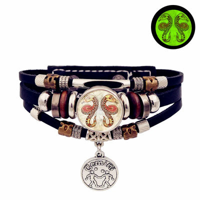 Multistrand bracelet with gemini charm on a white background