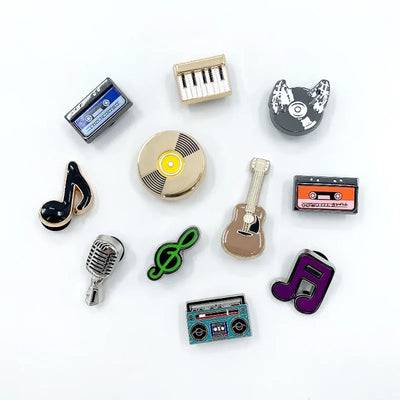 Collection of music-themed shoe charms on a white background