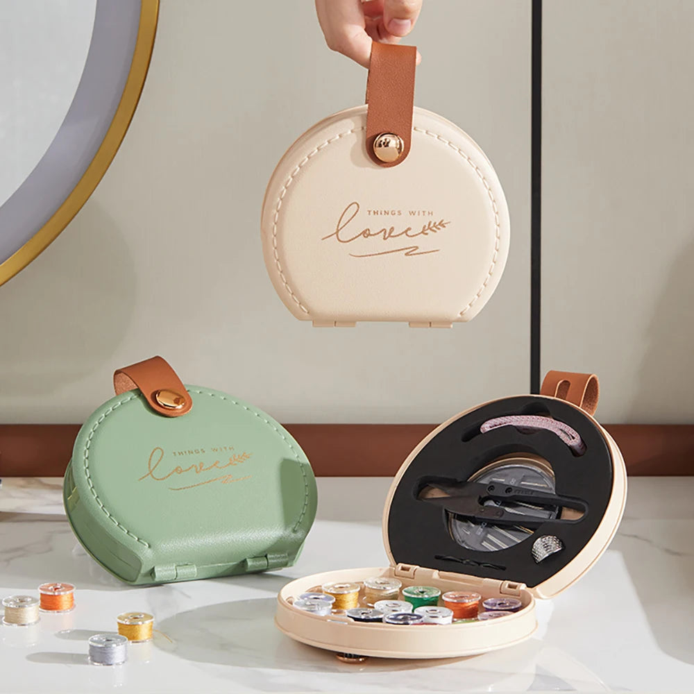 Round mini travel sewing kit repair case with a hand holding it and open one displaying contents on a neutral background.