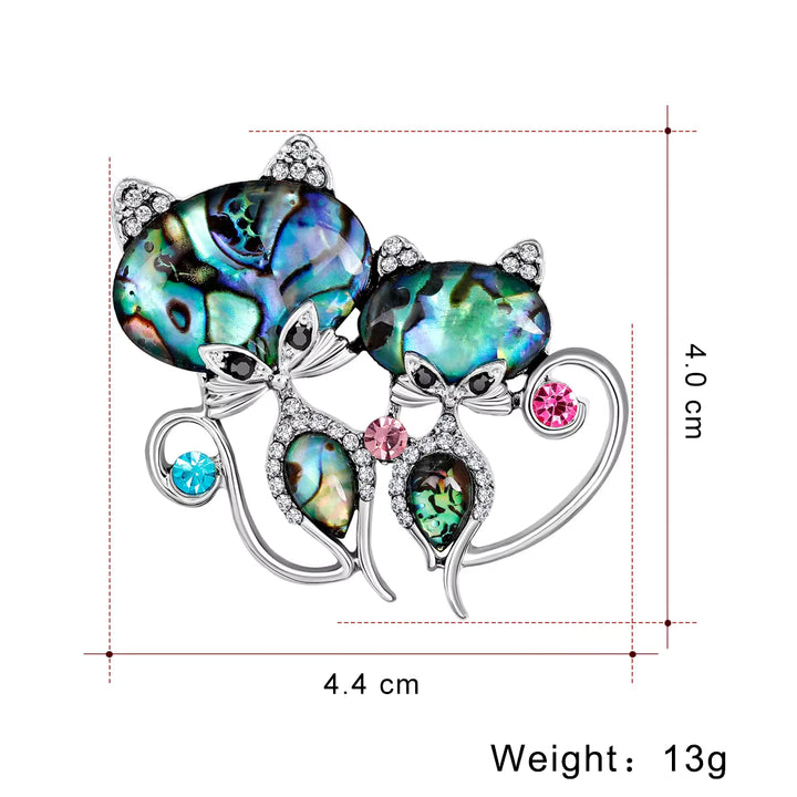 two cats Multicolored gemstone brooch with silver accents and measurements on a white background
