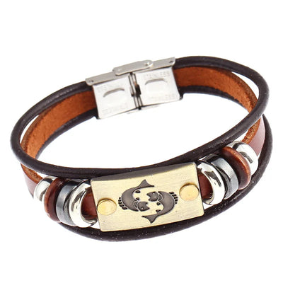 Bracelet with leather strap, metal tag, and circular elements on a white background
