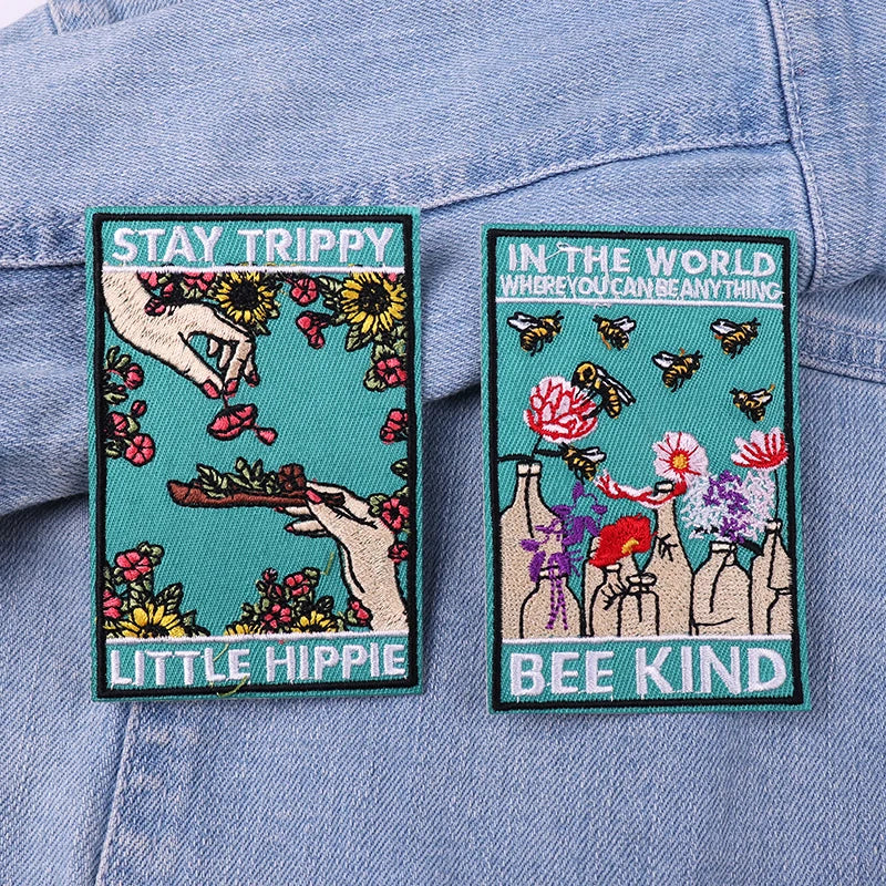 Two colorful patches with text and illustrations on a denim background