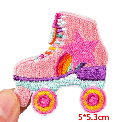 Embroidered patch of a pink roller skate held by a hand on a white background