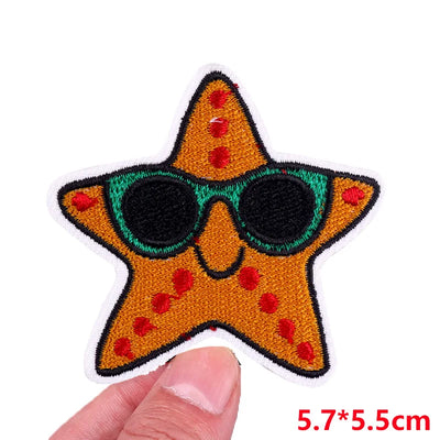 Star-shaped patch with sunglasses held by a hand, on a white background
