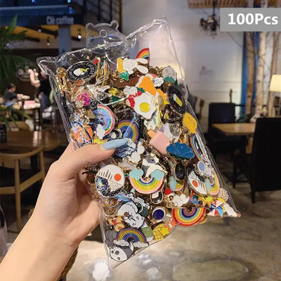 Hand holding a clear plastic bag filled with colorful decorative pins in an indoor setting.